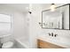 Bright bathroom featuring a tub-shower combo, modern vanity, and stylish fixtures at 4131 Osage St, Denver, CO 80211