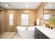 Luxurious bathroom with walk-in shower, modern soaking tub, and sleek vanity at 4131 Osage St, Denver, CO 80211