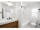 Well-lit bathroom with a shower-tub combo, contemporary vanity, and matte black fixtures at 4131 Osage St, Denver, CO 80211
