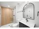 Modern bathroom featuring a walk-in shower with wood-look accent wall and a sleek vanity at 4131 Osage St, Denver, CO 80211