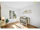 Bright bedroom with a crib, hardwood floors, and natural light from the large windows at 4131 Osage St, Denver, CO 80211