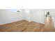 Well-lit bedroom featuring hardwood floors, white walls, a window, and a closet with sliding doors at 4131 Osage St, Denver, CO 80211