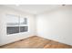 Sunlit bedroom with hardwood floors and a large window offering ample natural light at 4131 Osage St, Denver, CO 80211