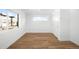 Clean, bright bedroom with hardwood floors, large windows, and a spacious closet with sliding doors at 4131 Osage St, Denver, CO 80211