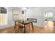 Well-lit dining area with a modern table and transparent chairs, next to a fireplace at 4131 Osage St, Denver, CO 80211