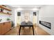 Open dining room with modern light fixture, built in shelves, and a black dining table at 4131 Osage St, Denver, CO 80211