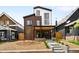 Inviting modern two-story home featuring a striking brick facade, black trim, and manicured front yard at 4131 Osage St, Denver, CO 80211