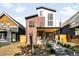 Inviting home with a modern brick and siding exterior, well-kept landscaping, and a covered front porch at 4131 Osage St, Denver, CO 80211