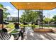 Inviting front porch with wood ceiling and seating area, perfect for enjoying the neighborhood views at 4131 Osage St, Denver, CO 80211