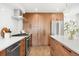 Well-appointed kitchen with wood cabinets, modern appliances, stone countertops and backsplash at 4131 Osage St, Denver, CO 80211