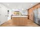 Bright kitchen featuring custom cabinets, stainless steel appliances, and large center island at 4131 Osage St, Denver, CO 80211