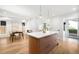 Open kitchen featuring a large island with white countertops, and hardwood floors at 4131 Osage St, Denver, CO 80211
