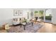 Bright living room with glass doors to backyard, stylish decor, and a cozy seating area at 4131 Osage St, Denver, CO 80211