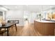 Open-concept living room with fireplace, seamless transition to the modern kitchen and dining area at 4131 Osage St, Denver, CO 80211