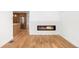Cozy living room featuring a modern fireplace, hardwood floors, and a glimpse into the kitchen at 4131 Osage St, Denver, CO 80211