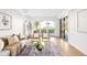 Bright living room with glass doors to backyard, stylish decor, and a cozy seating area at 4131 Osage St, Denver, CO 80211