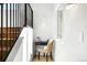 Staircase featuring hardwood stairs, black metal railings, and a small desk at 4131 Osage St, Denver, CO 80211
