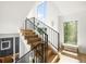 Staircase featuring hardwood stairs, black metal railings, and large windows for natural light at 4131 Osage St, Denver, CO 80211