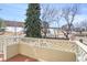 A private balcony with decorative railing that offers a pleasant view of surrounding landscape and winter scene at 209 W Jamison Cir # 32, Littleton, CO 80120