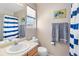 Neat bathroom featuring a shower with striped curtain, framed art, and coordinated towels at 209 W Jamison Cir # 32, Littleton, CO 80120