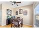 Inviting dining room with a wooden table set, stylish decor, and a modern ceiling fan at 209 W Jamison Cir # 32, Littleton, CO 80120