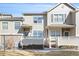 Charming townhouse with neutral siding, stone accents, well-maintained landscaping, and a welcoming front porch at 209 W Jamison Cir # 32, Littleton, CO 80120