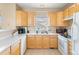 Bright kitchen with updated appliances, lots of counter space, and warm wood cabinets at 209 W Jamison Cir # 32, Littleton, CO 80120