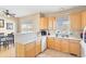 Bright kitchen with updated appliances, lots of counter space, and warm wood cabinets at 209 W Jamison Cir # 32, Littleton, CO 80120