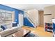 Bright living area with hardwood floors, a staircase, and light-filled windows at 209 W Jamison Cir # 32, Littleton, CO 80120