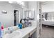 Bright bathroom featuring a vanity area, open shelving, and a view into the bedroom at 209 W Jamison Cir # 32, Littleton, CO 80120