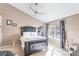Comfortable main bedroom with a decorative headboard, soft carpeting, and a bright window at 209 W Jamison Cir # 32, Littleton, CO 80120