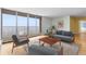 Bright living room with large windows, balcony access, and stylish furnishings. Ready to relax and enjoy the view! at 955 Eudora St # 1106, Denver, CO 80220