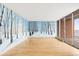 Bright living room features wood floors, a balcony, and a beautiful mural that brings the outdoors inside at 955 Eudora St # 1106, Denver, CO 80220