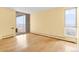 Open living room boasts ample natural light and easy balcony access, enhanced by wood floors and neutral decor at 955 Eudora St # 1106, Denver, CO 80220