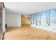 Spacious living room with wood floors, a nature mural, and large windows offering plenty of natural light and balcony access at 955 Eudora St # 1106, Denver, CO 80220