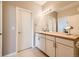 Bright bathroom featuring a granite countertop, framed mirror, and well-lit vanity at 22580 E Ontario Dr # 202, Aurora, CO 80016