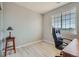 Bright office/bedroom with large window and a comfortable black desk chair at 22580 E Ontario Dr # 202, Aurora, CO 80016