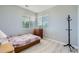 Bedroom featuring two windows, hard wood floors, and neutral color scheme at 22580 E Ontario Dr # 202, Aurora, CO 80016