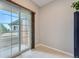 Balcony access with Sliding glass door, light tile floor and partial view of neighborhood at 22580 E Ontario Dr # 202, Aurora, CO 80016