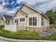 View of home with stone accents, and landscaping at 6924 W Euclid Pl # A, Littleton, CO 80123