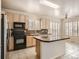 Bright kitchen features wooden cabinets, granite countertops, and stainless steel appliances at 6924 W Euclid Pl # A, Littleton, CO 80123