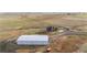 An aerial view shows the property and a large workshop shed on the grounds at 942 S County Road 129 Rd, Bennett, CO 80102