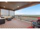 This cozy covered deck includes comfortable seating and a beautiful outdoor view at 942 S County Road 129 Rd, Bennett, CO 80102