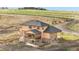 Exterior angle of two-story home boasts a porch, walkout basement, and lush green yard at 942 S County Road 129 Rd, Bennett, CO 80102