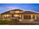 Stunning two-story home boasts a manicured lawn and an attached three-car garage with stone accents at 942 S County Road 129 Rd, Bennett, CO 80102