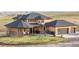 This charming home boasts a large front yard, covered porch, and three-car garage, perfect for families at 942 S County Road 129 Rd, Bennett, CO 80102