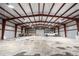 A massive warehouse space featuring tall ceilings, beams, and a truck at 942 S County Road 129 Rd, Bennett, CO 80102