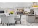Open-concept kitchen and dining area with white cabinets, granite countertops, and pendant lighting at 942 S County Road 129 Rd, Bennett, CO 80102
