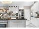 Modern kitchen with granite countertops, stainless steel refrigerator, wine rack and elegant details at 942 S County Road 129 Rd, Bennett, CO 80102