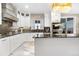 Beautiful kitchen with white cabinets, granite countertops, stainless steel appliances, and chic backsplash at 942 S County Road 129 Rd, Bennett, CO 80102